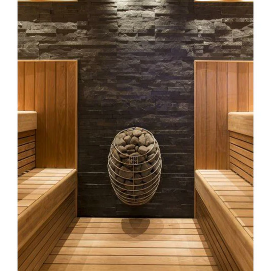 A wall-mounted electric sauna heater with a sleek, rounded design and stainless steel details, filled with sauna stones.