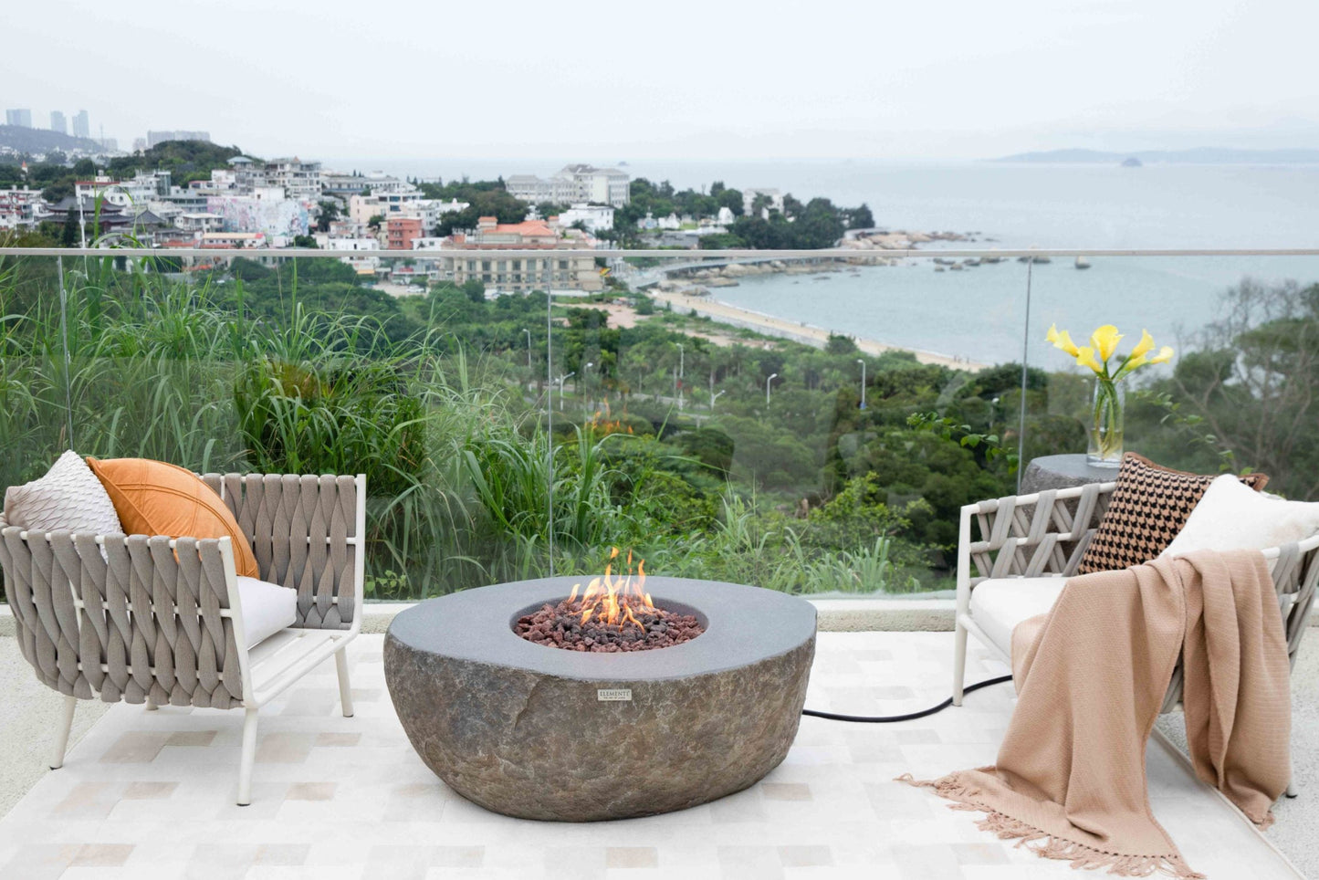 Outdoor seating area with fire pit and ocean view
