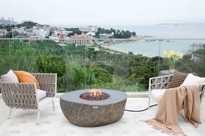 Outdoor seating area with fire pit and ocean view