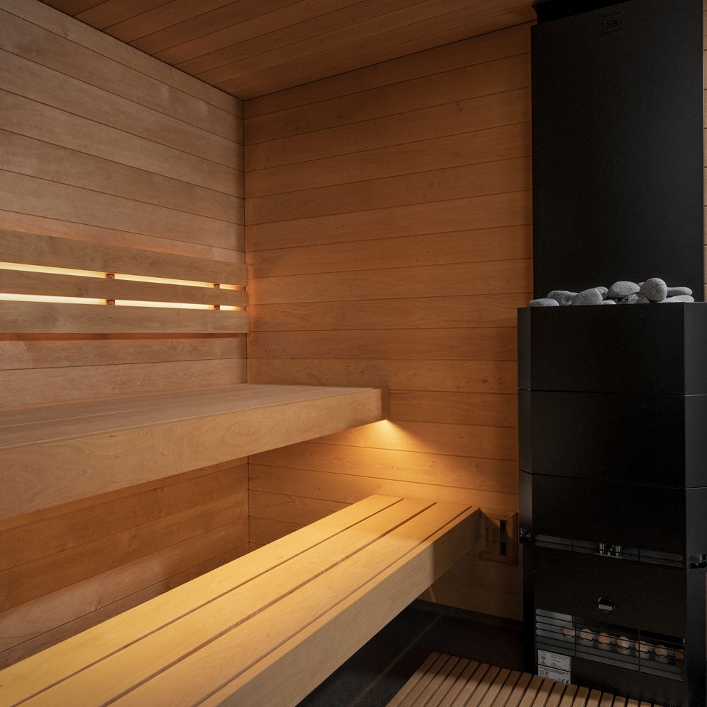 Wooden sauna interior with benches and a stove.