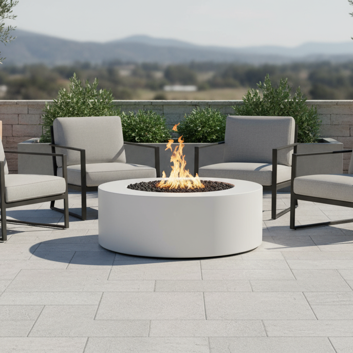 Outdoor patio with round white fire pit table and chairs on a sunny day