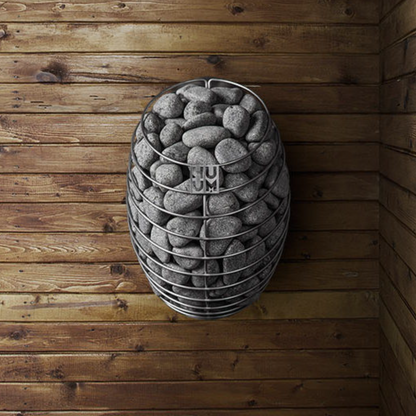 HUUM DROP sauna heater filled with stones against a wooden wall